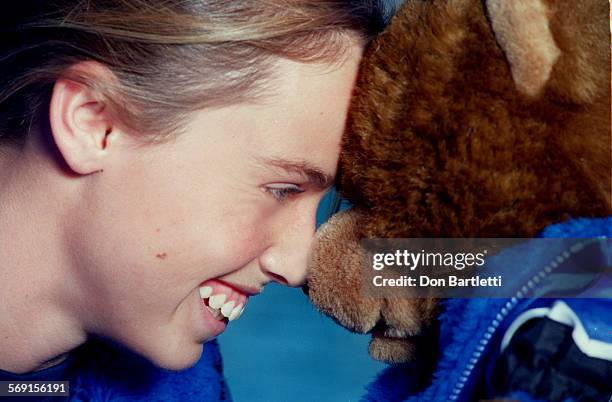 Beard.Noses2.DB.3/27/96.Irvine. 14yrold swimming prodigy and US Olympic team member Amanda Beard cuddles her new teddy bear that she takes to swim...