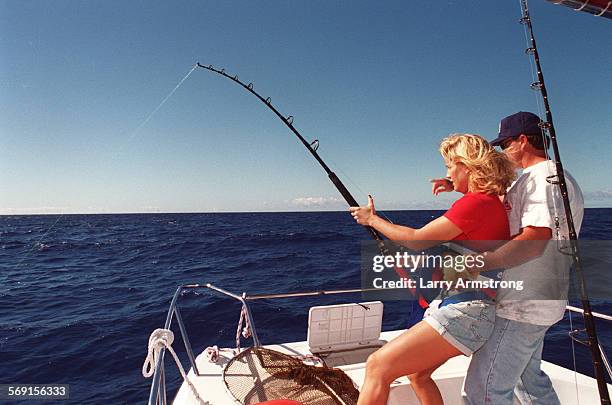 Midway.#2.1204.LA/G Fishing guide and captain Charlie Stuve holds onto his wife Cindy to prevent her from being pulled overboard by the 70 lb...