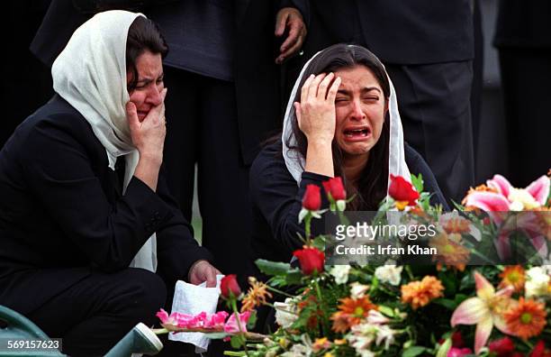 Grieving at the burial site of Singapore airlines crash victim Fuad Memon, of Aliso Viejo, are from left motherinlaw Amena Yakub , and wife Freba...