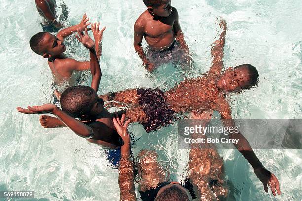 Heat.#1.0629.BC/cStephen Hill lays back in water at Will Rodgers Pool in Watts. His father, Kenneth Hill, supports him, bottom. Temperatures in...