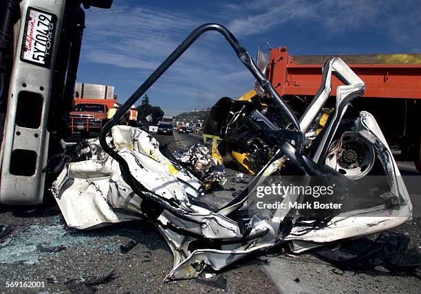 Fatal.Twist.112999.MBTwisted metal lay in the roadway after a truck driver slammed his vehicle into the back of a Cal Trans survey truck on the I5...
