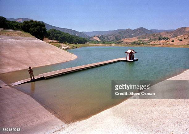 Doug West, recreation manager at Lake Piru stands on the boat launch dock at the lake .