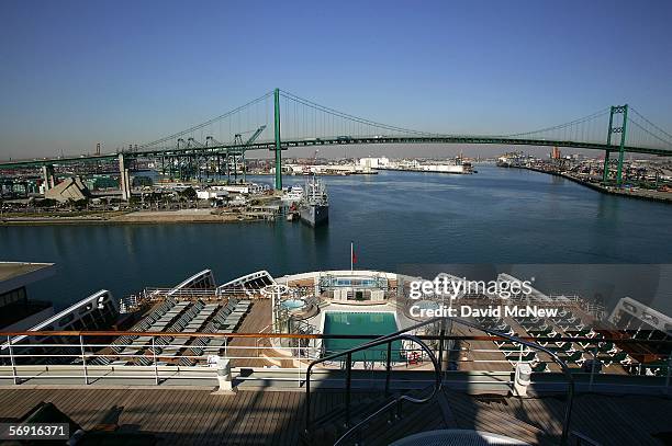 The Vincent Thomas Bridge is seen beyond the stern of the Queen Mary 2 Commodore Warwick cruise ship on its maiden call to the Port of Los Angeles...