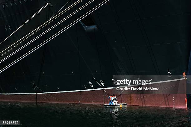 Painters touch-up the Queen Mary 2 Commodore Warwick cruise ship on its maiden call to the Port of Los Angeles February 22, 2006 at the Los Angeles,...