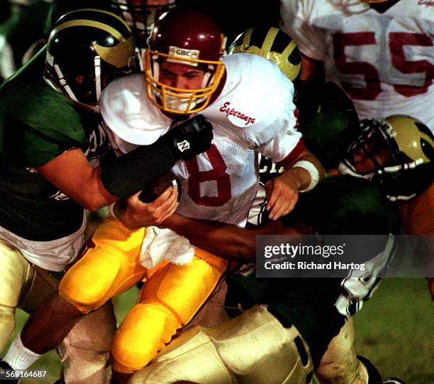 Football.Wagner.RH091898Esperanza High quarterback Grant Wagner is sandwiched between two Rancho Alamitos High defenders during 1st quarter...