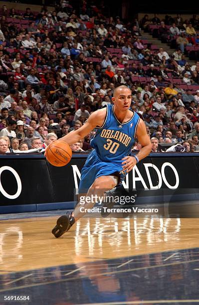 Carlos Arroyo of the Orlando Magic drives against the New Jersey Nets on February 22, 2006 at Continental Airlines Arena in East Rutherford, New...