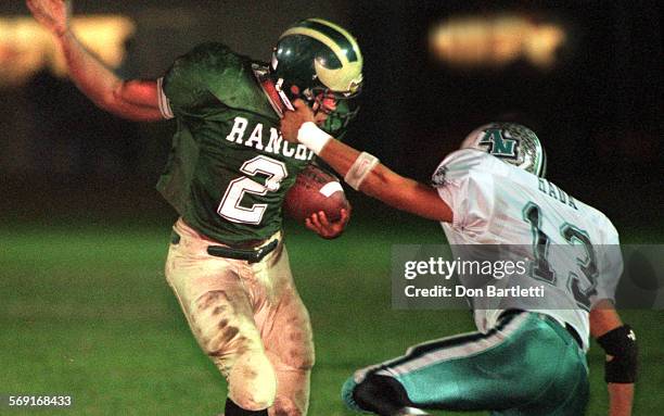 Football.Aliso.DB.11/21/97.GardenGrove. Aliso Niguel defensive back Rich Hada appears to snag the facemask of Rancho Alimitos running back David...