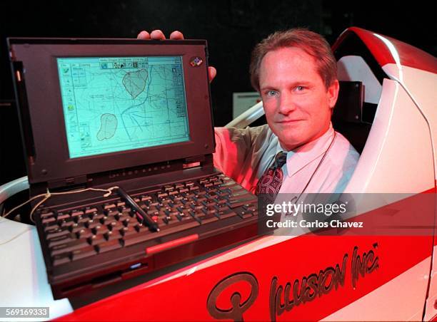 Matt Walton Ex. Vice Pres. At Illusion Inc. Sits in a computorized formula race car for interactive racing at the production plant in Westlake...