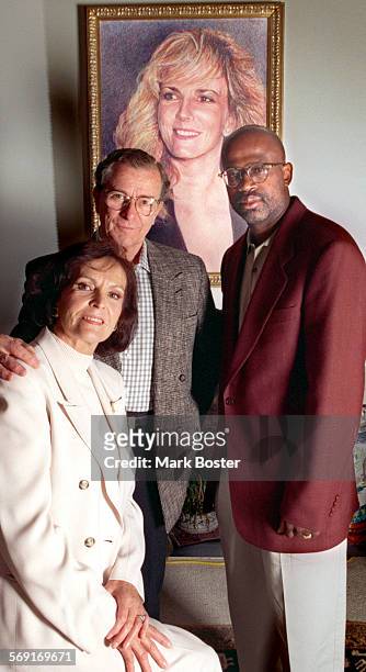 Juditha Brown, Louis Brown and Attorney Christopher Darden posed in front of a portrait of Nicole Brown Simpson in the Brown's living room.