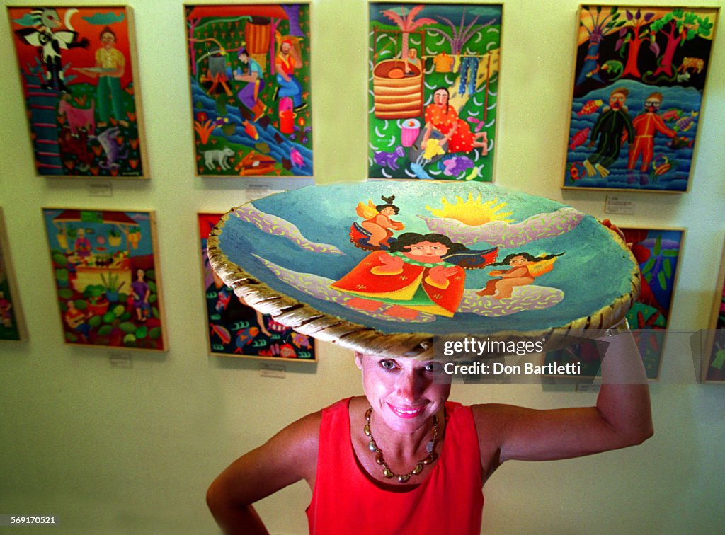 LS.Folk.Baker.DB.8/8/97.CostaMesa. Joanne Baker holds a painted basket by Costa Rican artist Lil Men