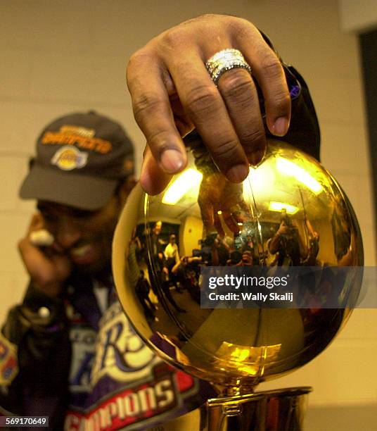 Lakers.21WS  Lakers Kobe Bryant Bryant hangs on to the Championship trophy after defeating the 76ers in Game 5 of the NBA Finals in Philadelphia...