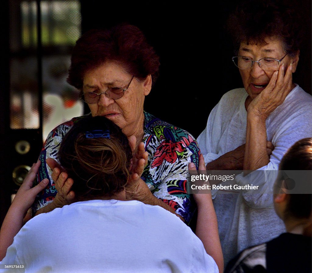 035763.ME.0912.family1.RG  Della Arellano, left and her sister Vita Valencia offer comfort to thei