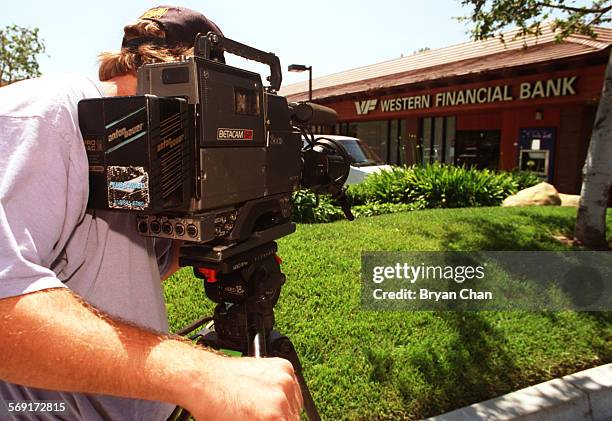 Cameraman Kevin Andersen films exterior shots of the Western Financial Bank in Thousand Oaks for the Fox's America's Most Wanted to air May 17.