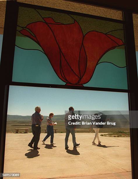 Poppy.3.bv.312/ANTELOPE VALLEY  Visitors to the Antelope Valley California Poppy Reserve are framed through a stainedglass window of a poppy at...