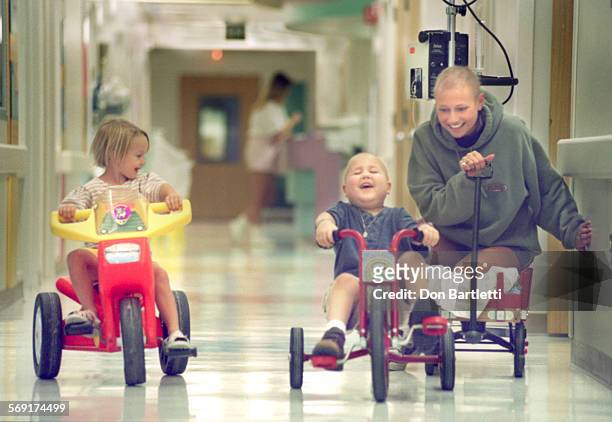 Mullen.Race.DB.10/1/96.Orange. Towing a chemotherapy I.V. Pump behind her toy wagon, 17yrold cancer patient Molli Mullen races down a hallway of...