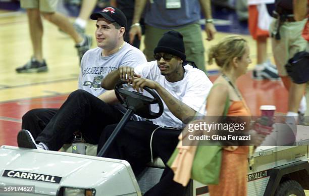 Sixers Allen Iverson cruises around the court in a golf cart at the end of practice Tuesday.