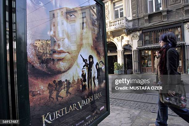 Girl walks past a billboard showing the poster of the new Turkish movie "Valley of the Wolves" , 03 February 2006 in downtown Istanbul. The movie is...