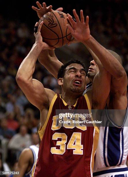 Usc/duke7.RG David Bluthenthal is blocked by Shane Battier in the second half at the NCAA East Regional final in Philadelphia, March 24, 2001