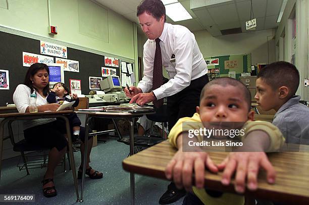 Travel.1.LS. Science teacher Paul Hession conferences with a parent in the Deans Office of Virgil Middle School in Los Angeles. Hession must travel...