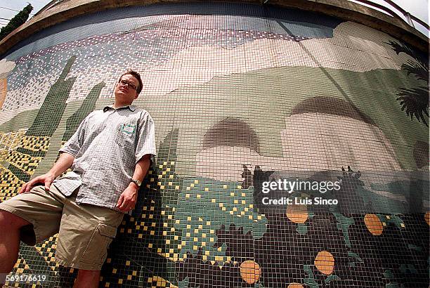 Mural.2.LS. Artist Lee McVetta stands beside his tile mural of the Griffith Observatory, which adorns stairway connecting Bonvue Avenue and Glencairn...