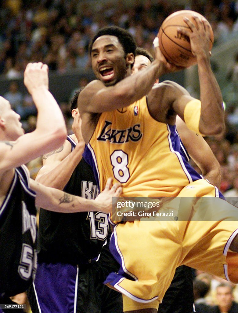 Laker Kobe Bryant pulls down an offensive rebound against Kings Jason Williams during Game 1 of the 
