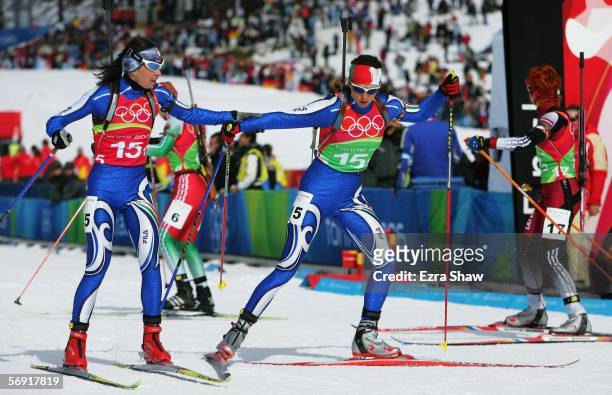 Michaela Ponza of Italy hands over to fellow countrywoman Saskia Santer during the Womens Biathlon 4x6km Relay Final on Day 13 of the 2006 Turin...