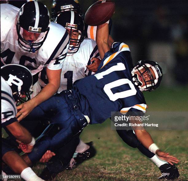 Pacifica.Huyhn.RH101698La Quinta High quarterback Thi Huyhn, right, ends up spreadeagled as he's sacked by a swarming Pacifica High defense...