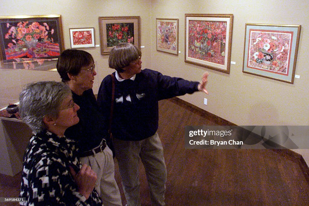 Chris Weber, left, Sue Stoutz and Mickey Short view the artwork of Susan Petty at the Ventuta County