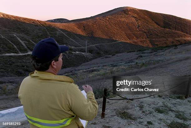 Ventura County Fire Captain Mark Acevedo, surveys hillsides from the top of Old Conejo Road in Thousand Oaks. Acevedo is part of the Task Force...