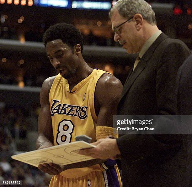 Lakers head coach Phil Jackson, right, plots strategy with Kobe Bryant during a game against Detroit at the Staples Center. DIGITAL IMAGE SHOT