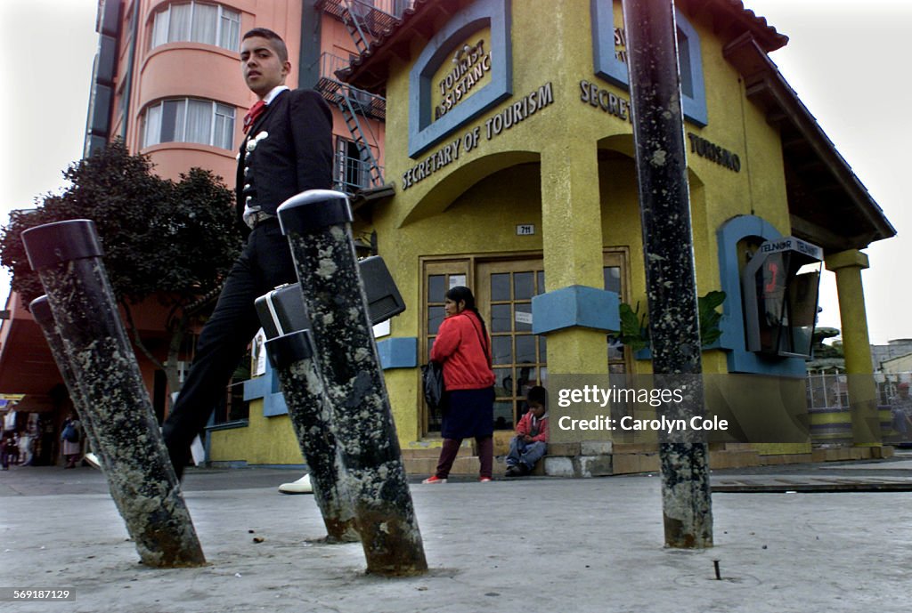 020628.ME.1204.clock5.cc; A mariachi player walks by the proposed site in downtown Tijuana of a 200