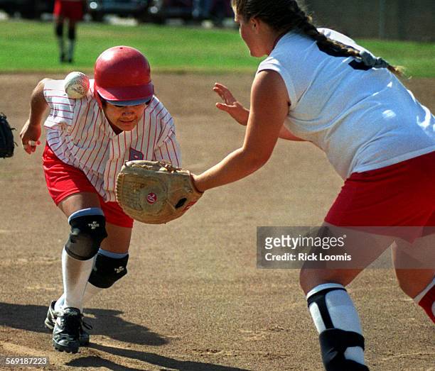 Softball.shoulder.0501.RLGarden GroveBolsa Grande's Erica Delos Santas makes her way safely to third base as the ball rolls off her shoulder after...