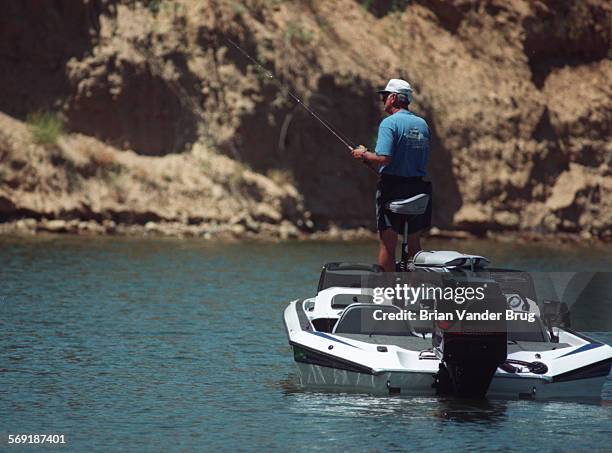 Bass.1.bv.514/CASTAIC  A bass fisherman plies the waters of Castaic Lake in search of record bass. The record bass at Castaic tipped the scales at...