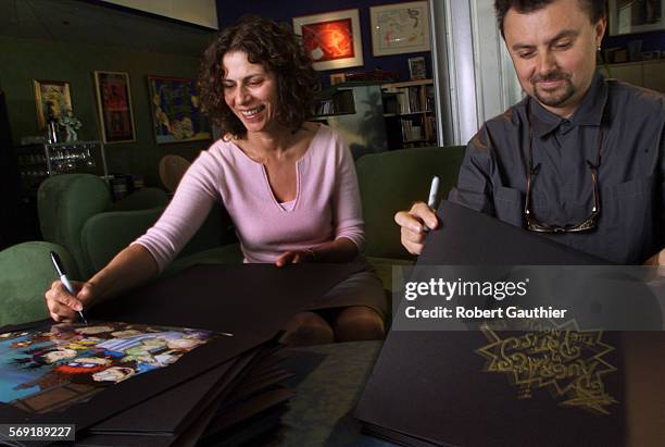 Rugrats.1.RG Arlene Klasky, left and Gabor Csupo autograph cels from the Rugrats in Paris movie at their Hollywood office, Wednesday, November 8,...