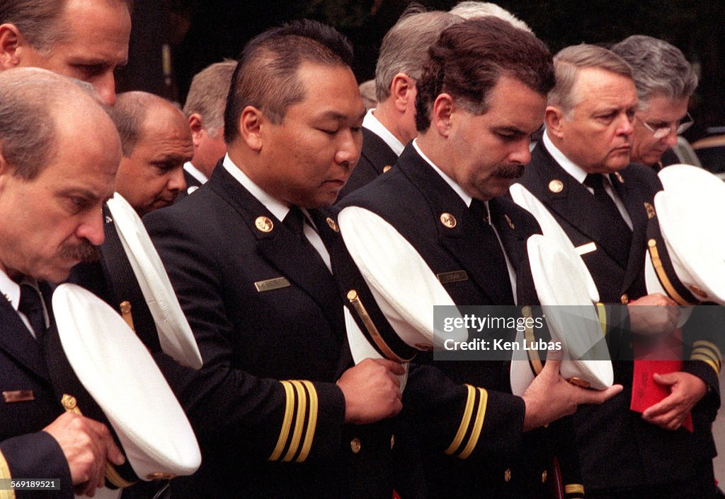 Los Angeles City Fire Department officers bow their heads in memory of fallen comrades during 56th a