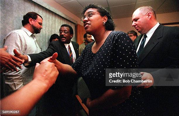 Tina LeeVogt shakes hands as she leaves news conference called by her lawyer Johnnie L. Cochran after he talks about the case of her brother,...