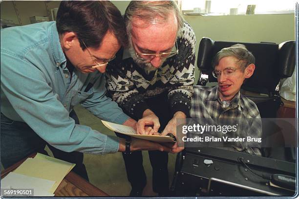 Hawking.2.bv.25/PASADENA  Theoretical physicist Stephen Hawking, right, gets help "signing" his name with a thumbprint from colleagues Kip Thorne,...