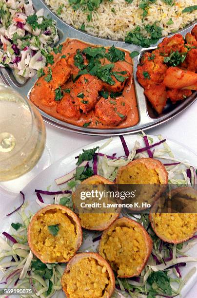 Restaurant review of Surya, South Asia cuisine with dishes like Chicken Tikka Masala and Paneer Pakoras witha glass of Chardonnay.