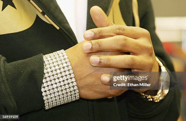 Rapper Nelly's jewelry is seen as he holds a news conference at the MAGIC convention at the Las Vegas Convention Center February 22, 2006 in Las...