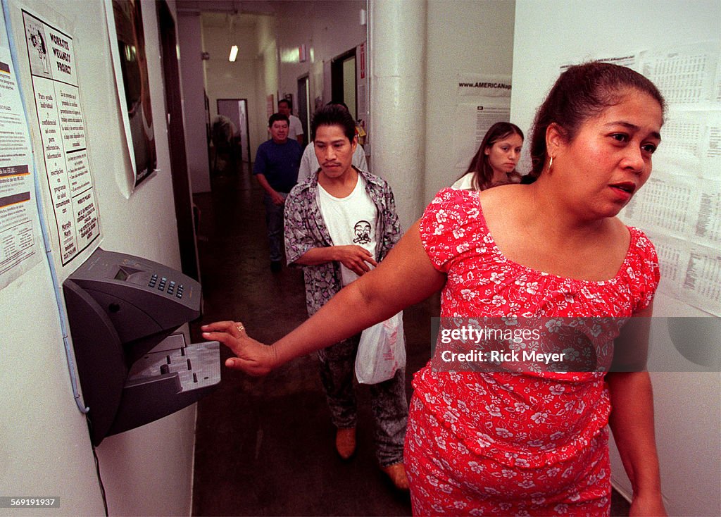 016654.ME.0929.strike2.rm Photo shows employees punching the timeclock (entering ID number and make 
