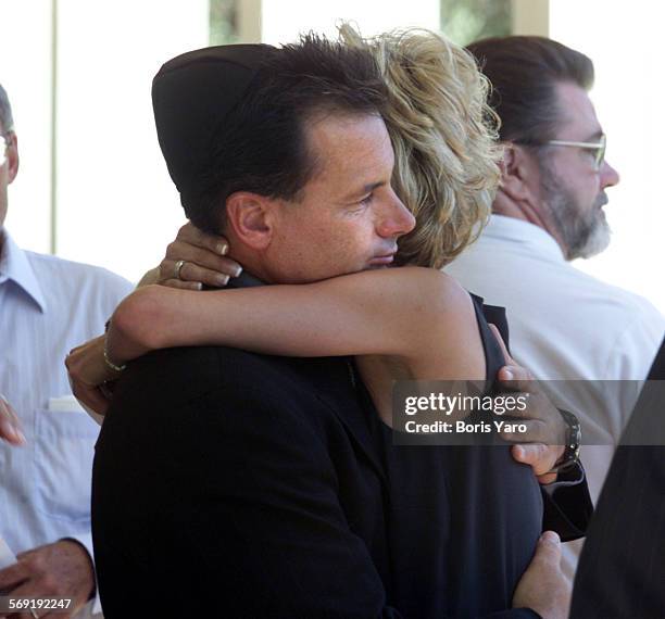 Monte Markowitz uncle of slain teenager Nicholas Samuel Markowitz is consoled at memorial services for his son on Aug. 18.00.