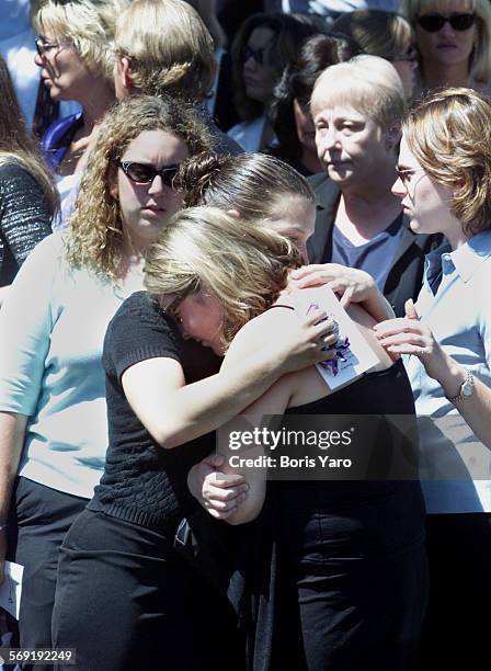 Friends of slain teenager Nicholas Samuel Markowitz console one another after memorial services for the youth.