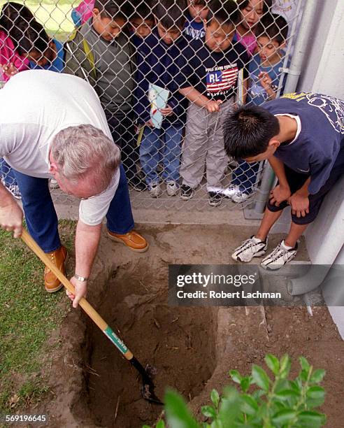 Capsule2.rl At Sunnyside Elementary School in Garden Grove, principal Tom Wilson helps dig along with many other students a hole trying to find...