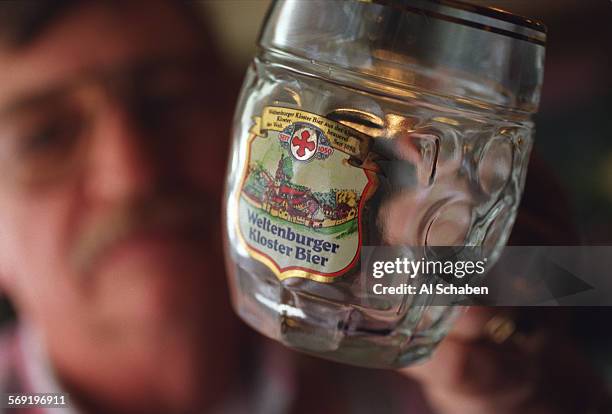 Jagerhaus2.AS Gus Riker, owner of Gustav's Jägerhaus holds up a mug with the "Weltenburger Kloster Bier" logo on it. Weltenburger is Gus' favorite...