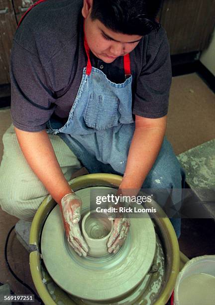 Hillview.clay.0514.RLSanta AnaErnesto Valdez of Tustin, works with a pottery wheel during art class at Hillview High School in Santa Ana. The...
