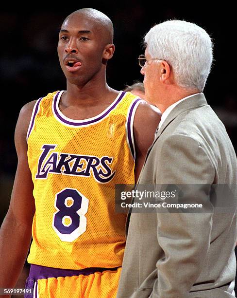 Laker rookie, 18yearold Kobe Bryant listens to coach Del Harris during a break in the action during game earlier this season at the Forum.