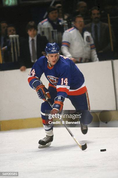 Canadian hockey player Bob Bourne of the New York Islanders skates with teh puck during a game at Madison Square Garden, New York, New York, 1980s.