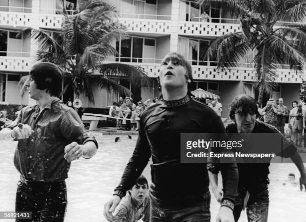 Members of the British pop group the Beatles climb out of a pool during filming of a movie, tentatively called 'Beatles 2,' Nassau, Bahamas, February...