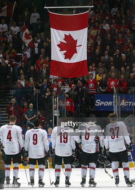 Team Canada line up at center ice for the raising of their national flag after prior to taking on Team Finland in their World Junior Hockey...