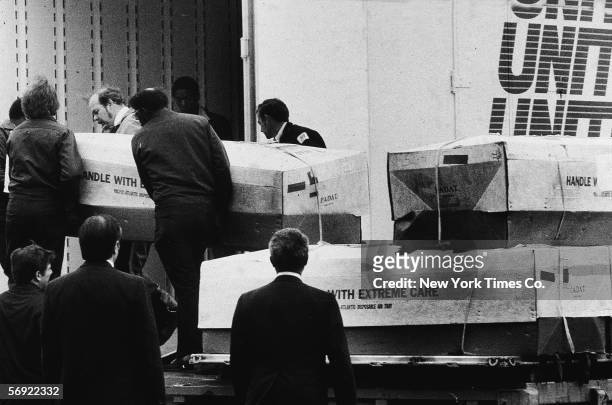 Men load coffins into a moving truck for transport in Dover, Delaware, April 26, 1979. The coffins all arrived from Jonestown, Guyana, where the...